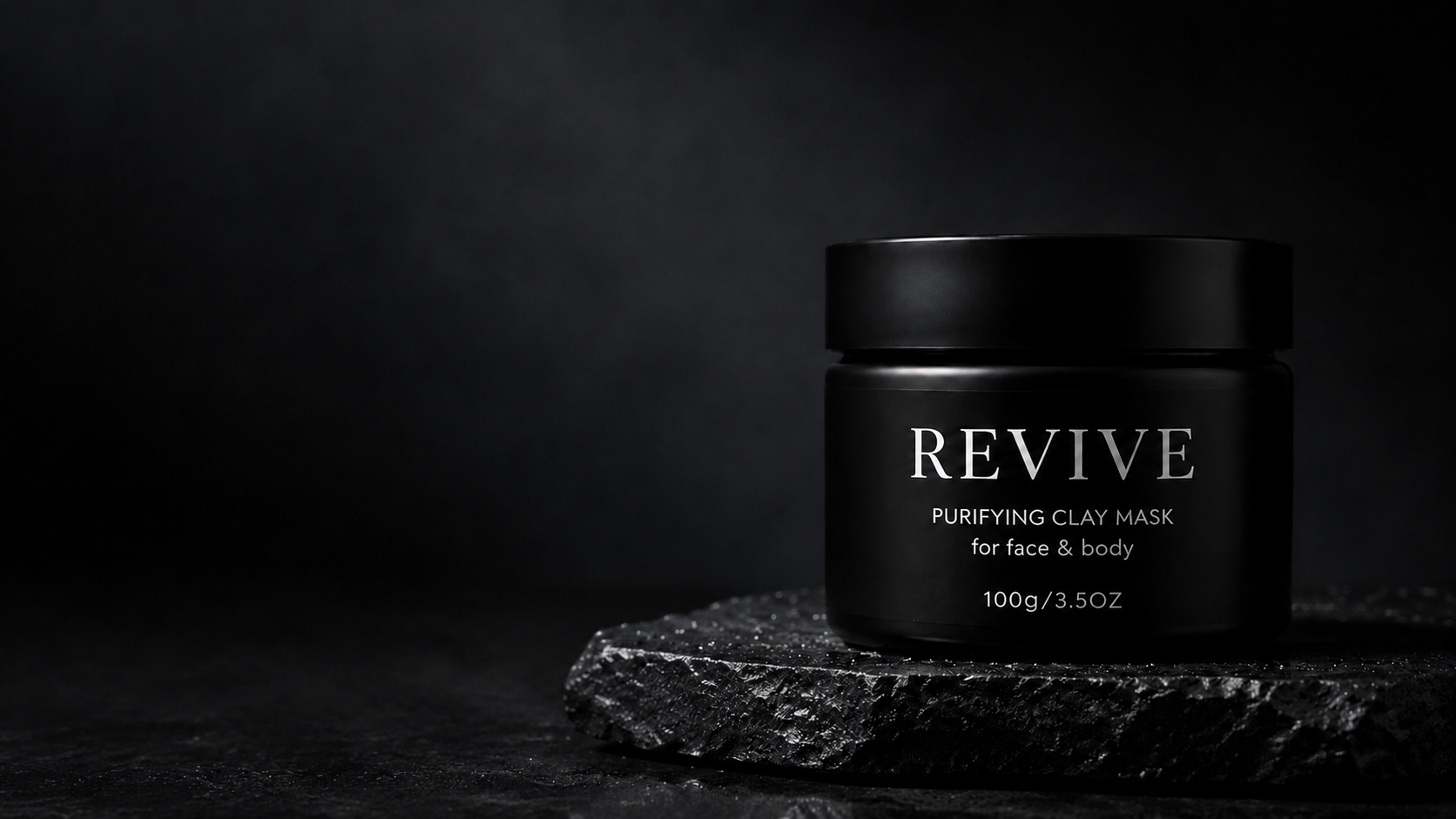 REVIVE Purifying Clay Mask jar on a dark stone slab, wide banner shot with open space to the left