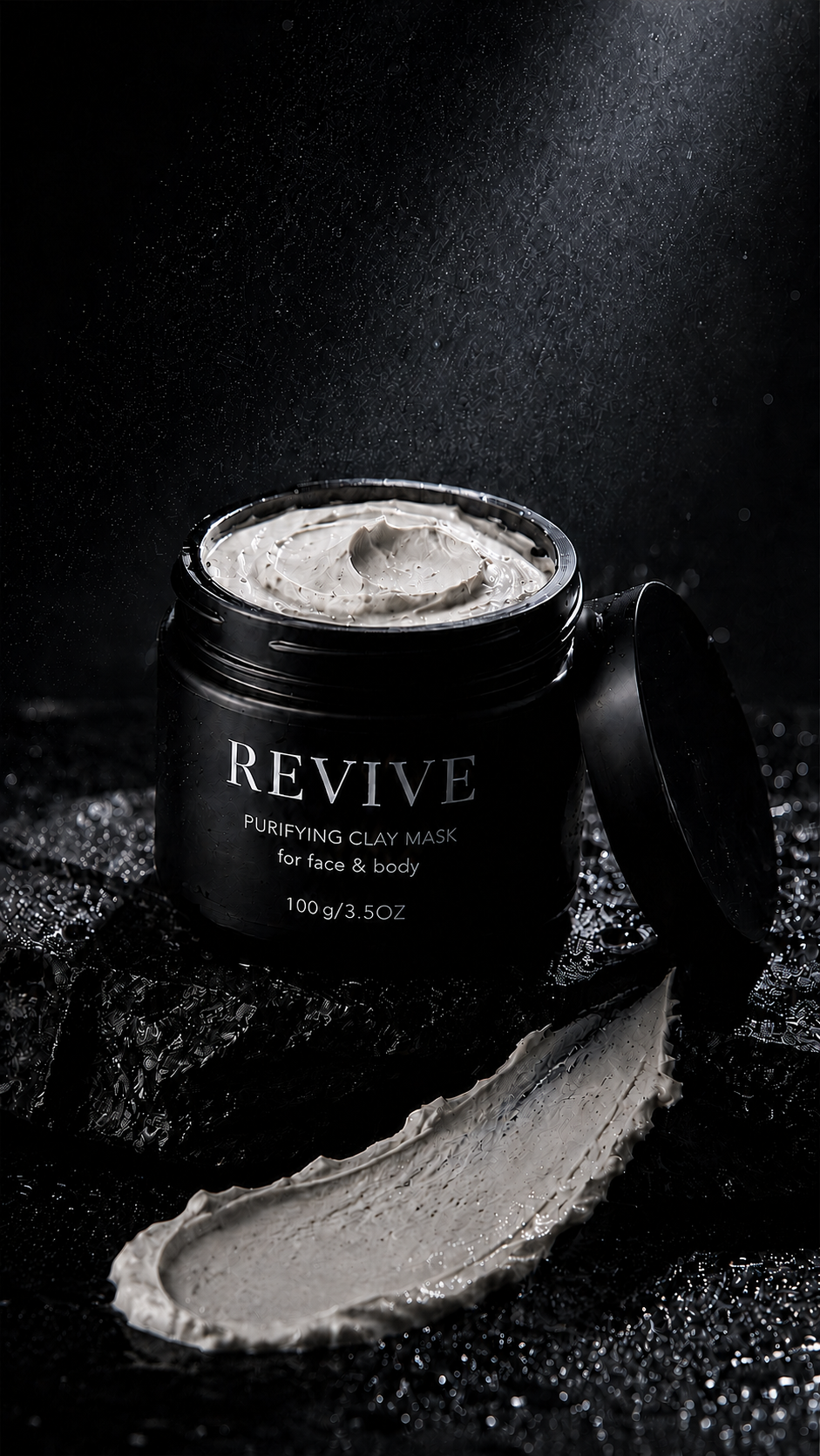 REVIVE Purifying Clay Mask jar open with the lid resting against it and a thick clay swatch on wet black stone