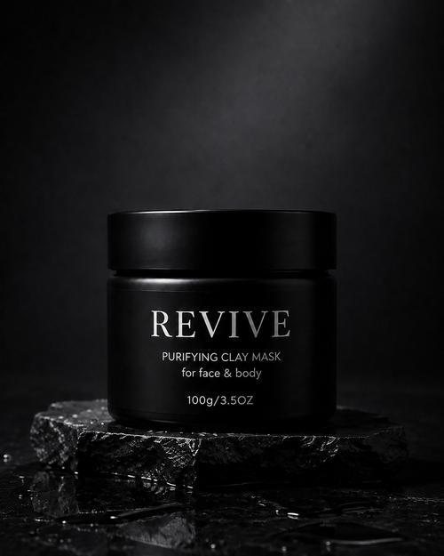 Closed black REVIVE Purifying Clay Mask jar, 100g, standing on a wet slate slab against a dark background